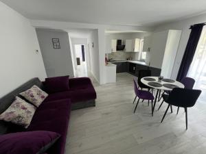 a living room with a couch and a table and chairs at Forest View in Câmpulung Moldovenesc +9 photos