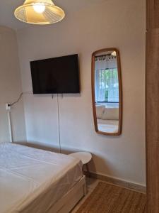 a small bedroom with a bed and a mirror at Small heaven of privacy and tranquility in Milies Stavros in Stavros