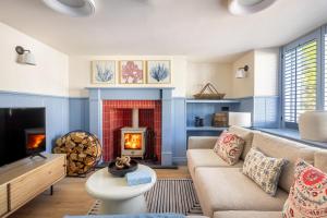a living room with a couch and a fire place at 49 Wexham in Beaumaris