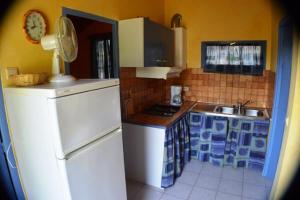 a small kitchen with blue and white appliances at Chalet #15, 4 pers, Domaine De Ribiere in Grospierres