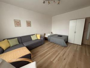 a living room with a couch and a bed at PA - Peaceful Parkside Apartment in KoÅ¡ickÃ© KÃºpele