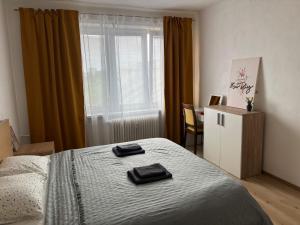 a bedroom with a bed with two towels on it at PA - Peaceful Parkside Apartment in KoÅ¡ickÃ© KÃºpele