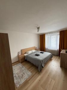 a bedroom with a bed and a large window at PA - Peaceful Parkside Apartment in KoÅ¡ickÃ© KÃºpele