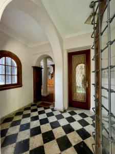 a room with a black and white checkered floor at Hostel Plaza in Mendoza