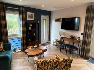 a living room with a table and a dining room at The Wee Bothy in Oban
