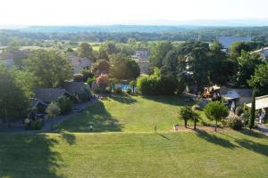 an aerial view of a green field with houses and trees at Maisonette #17, 4 Pers, Domaine De Ribiere in Grospierres