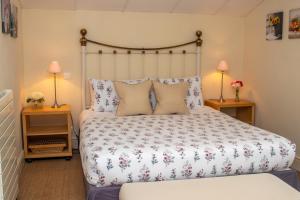 une chambre avec un grand lit avec deux lampes dans l'établissement Jasmin Cottage, à Montayral