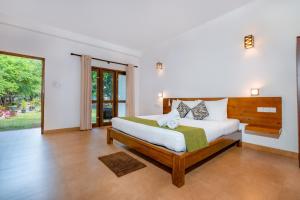 a bedroom with a large bed in a room at Tropicara Resort in Sigiriya