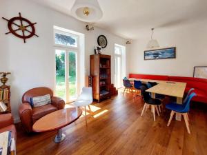 a living room with a couch and a table and chairs at Domaine Duchentyls Chambres d hotes in Le Palais
