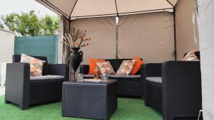 a patio with two wicker chairs and a table at A Devesa in Noya