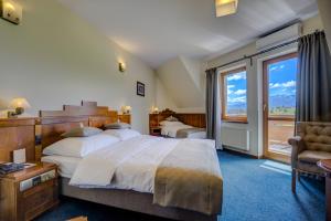 Postel nebo postele na pokoji v ubytování Hotel REDYK Ski&Relax
