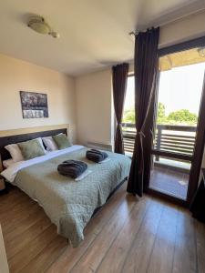 a bedroom with a bed and a large window at Alpine Lodge Chalet in Bansko in Bansko +68 photos