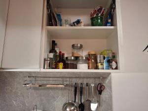 a kitchen cabinet with a bunch of kitchen utensils at Mountain View Studio Apartment in Poprad