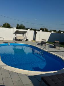 a large blue swimming pool in a yard at Casa Sofia&Miruna in Vladimirescu