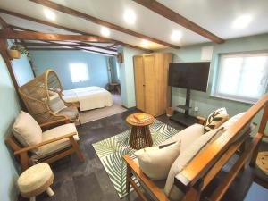 a living room with a bed and a couch and a television at Haus der Wonne nähe Berzdorfersee -Görlitz in Görlitz
