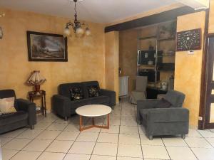 a living room with couches and a table at Maison de Campagne in Trézelles