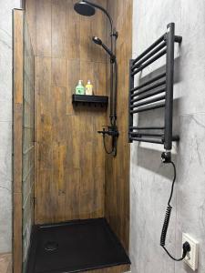 a shower in a bathroom with a black shower head at Zveryno City Appartments in Vilnius