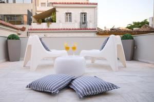 a table and two chairs and wine glasses on a balcony at Ma Maison N9 Downtown Villa, Jacuzzi, Parking in Athens +85 photos