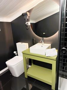 a bathroom with a sink and a toilet at Delux LEIRIA Side in Leiria +15 photos