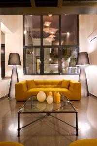 a yellow couch in a living room with two lamps at Ma Maison N9 Downtown Villa, Jacuzzi, Parking in Athens