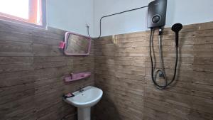 a bathroom with a sink and a mirror at Green Mart Family Rest in Anuradhapura +21 photos