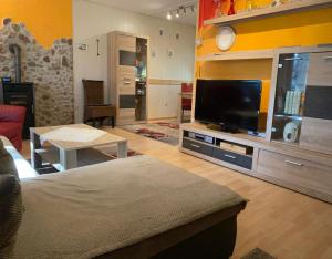 a living room with a large flat screen tv at Ferienhaus am Wald in Friedrichroda