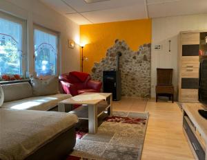 a living room with a couch and a table at Ferienhaus am Wald in Friedrichroda