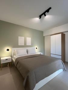 a bedroom with a large bed with white pillows at M P A Luxury Apartment A1 in Agios Nikolaos