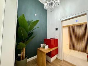 a hallway with a table and a plant in a room at Le Suite del Duomo in Cava deʼ Tirreni