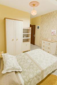 a bedroom with a large bed and a dresser at Appartement sur tanger - pour vacance in Tangier