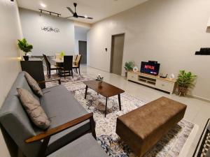 a living room with a couch and a table at Ssri Homestay Temerloh in Temerloh