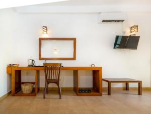 a wooden desk with a chair and a mirror at Tropicara Resort in Sigiriya +60 photos