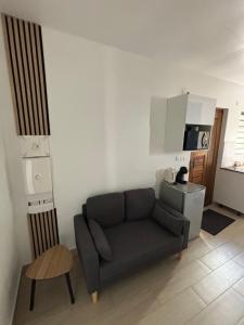 a living room with a couch and a table at Sleep in Guyane - Saint-Laurent-du-Maroni in Saint-Laurent du Maroni +2 photos
