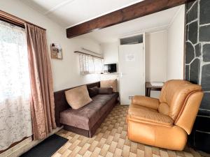 a living room with a couch and a chair at Thak in Francorchamps