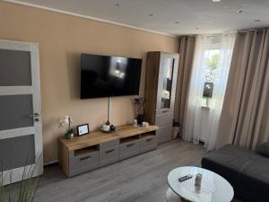 a living room with a flat screen tv on the wall at Ferienwohnung im Harz 2 in Goslar