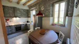a kitchen with a table and chairs in a kitchen at Torre de Codinac in Sant Pere de Torelló