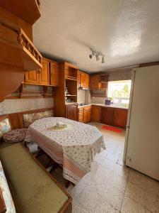 a kitchen with a table in the middle of it at Duplex lumineux à Sidi bou said in Dar Salah Bey