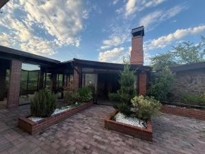a brick house with a brick patio with plants at View Cozia in Călimăneşti