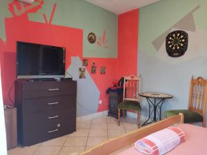a living room with a tv on a dresser at Apartment CENTER CRIKVENICA, SANDY BEACH, 2 bedrooms, in Crikvenica