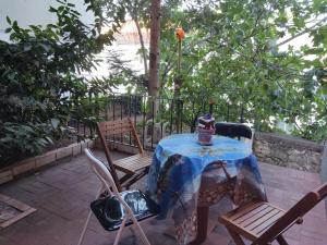 a table with a blue table cloth and two chairs at Apartment CENTER CRIKVENICA, SANDY BEACH, 2 bedrooms, in Crikvenica