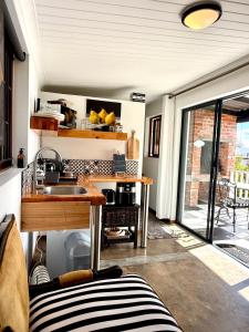 a room with a kitchen with a sink and a window at Salt & Pepper in Mossel Bay
