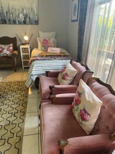 a living room with a couch and a bed at 80onBenade in Bloemfontein +41 photos