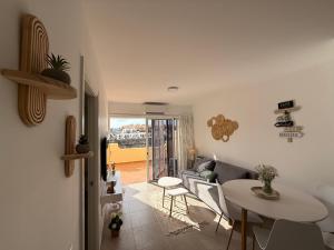 a living room with a couch and a table at Sunny Apartment Loma de Arguineguín in Arguineguín +35 photos