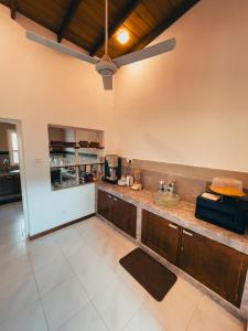 a large kitchen with a counter in a room at Windgate Estate Bungalow Galaha in Palle Deltota