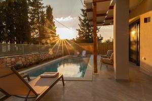 a swimming pool in a backyard with a house at Theoni House in Akrotiri