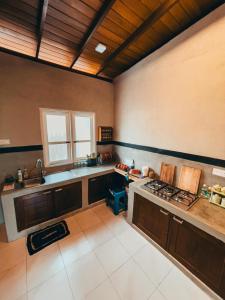 a large kitchen with a stove and a sink at Windgate Estate Bungalow Galaha in Palle Deltota +38 photos