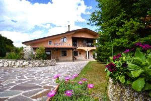 a large house with flowers in front of it at Hotel LA LOGGIA in Castel di Sangro