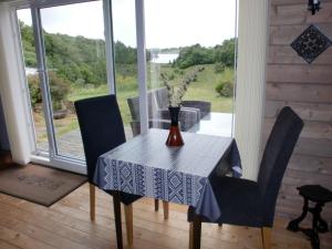 a dining room table with a vase of flowers on it at Tiny house in scenic surroundings in Farsund