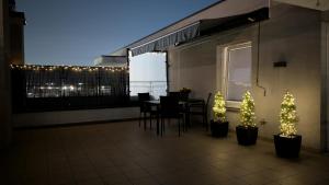 a balcony with a table and chairs and christmas trees at Apartament Białołęka in Warsaw