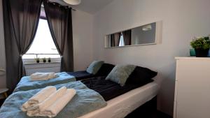 a bedroom with a bed with two towels on it at Apartament Białołęka in Warsaw